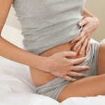 Young woman stroking her belly